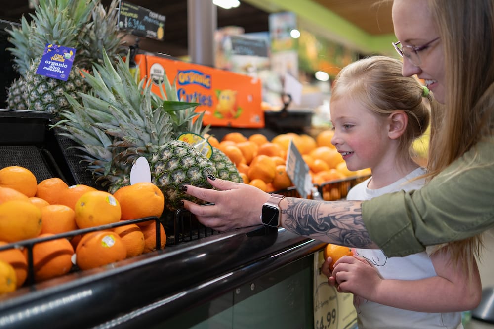 Mom and daughter grocery shopping.